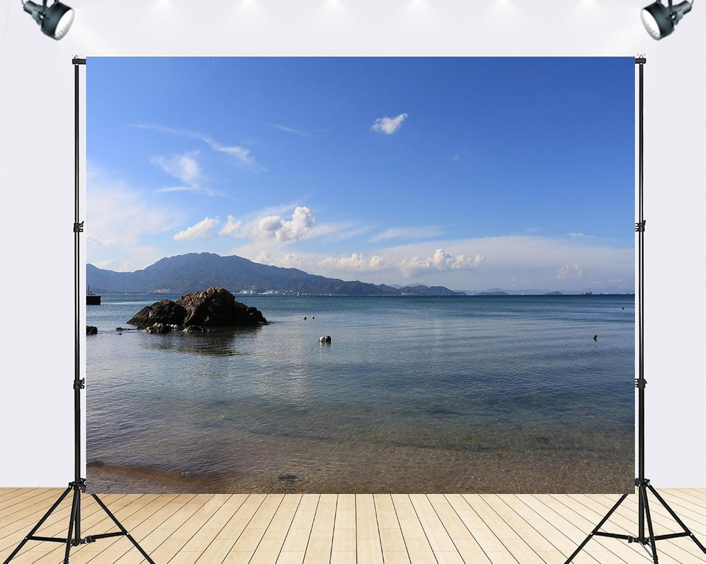 Trykid 20x10ft Tranquil Coastal Cove Backdrop Clear Turquoise Water Rocky Outcrop Distant Mountain Range White Clouds Photography Background Beach Party Decoration Photo Booth Prop Fabric