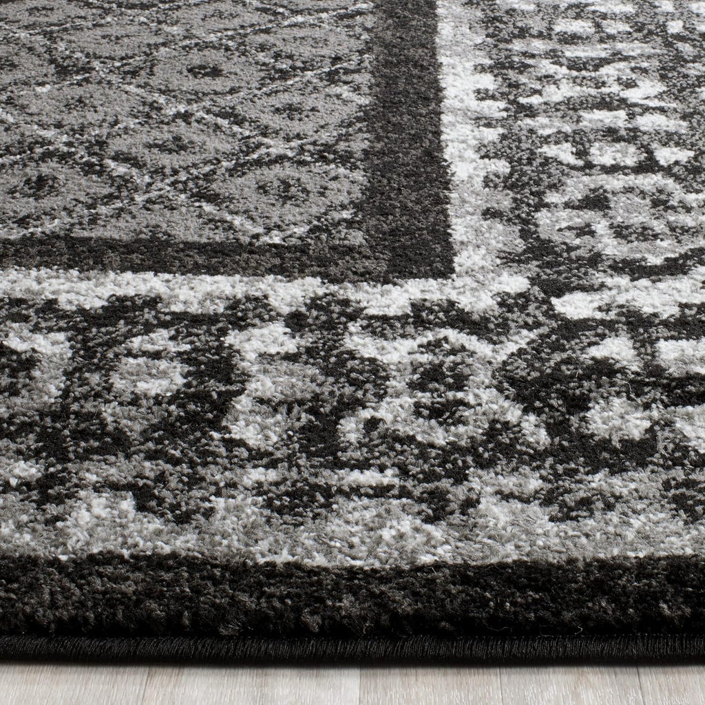 SAFAVIEH Adirondack Collection Area Rug - 9' x 12', Black & Silver, Distressed Design, Non-Shedding & Easy Care, Ideal for High Traffic Areas in Living Room, Bedroom (ADR110A)